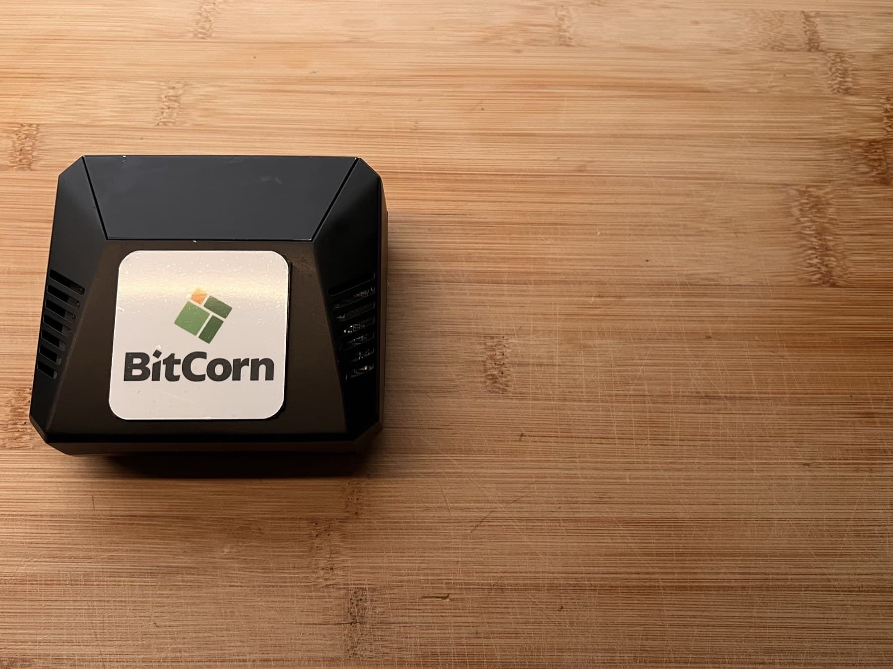 The BitCorn Node — a compact hardware device on a wooden desk